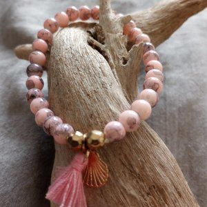 Pink and gray beaded bracelet with gold shell charm and pink tassle